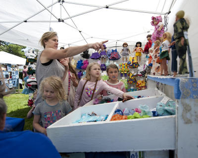 Mother and kids exploring a craft show in Minocqua