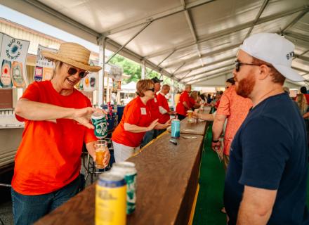 A volunteer pouring a beer at Main Street Fest