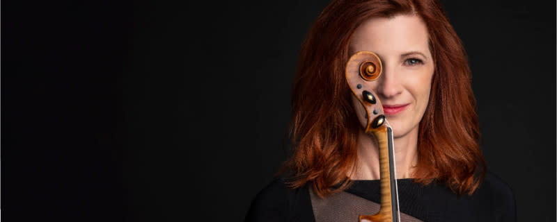 A woman poses with her string instrument