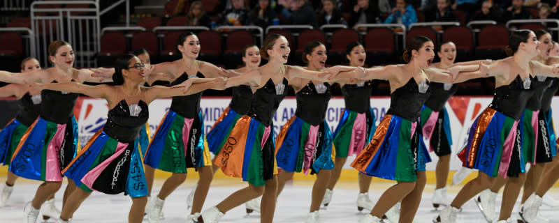 Figure skaters perform on the ice