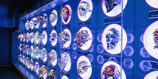 A wall of hockey helmets at the Hockey Hall of Fame