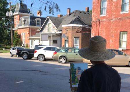 Artist painting the Hendricks County Historical Museum (Photo courtesy of the Gallery on the Square Facebook page)