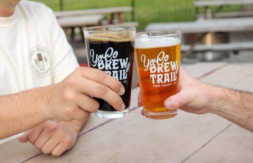 Two arms cheersing beers together