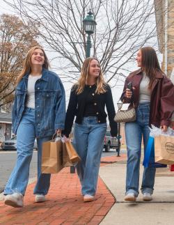 Girls Shopping in Downtown Selinsgrove - Three Girls Walking down market street in Selinsgrove PA with shopping bags in hand and smiles on their faces.