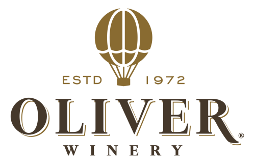 Gold/brown logo reading "Oliver Winery." Over the words is a hot air balloon drawing surrounded by the words "ESTD 1972"