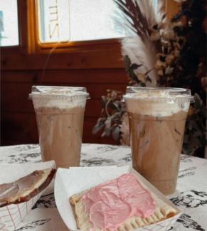 Two iced coffee beverages sit behind two homemade poptarts on a table at The Chow Korral