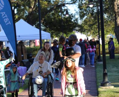 Women in a wheelchair spending time with family at an event.