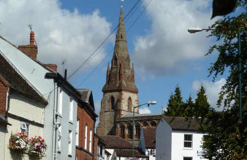 A picture of a church and buildings in Southam