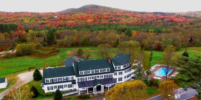 traditional New England Inn with fall foliage in background
