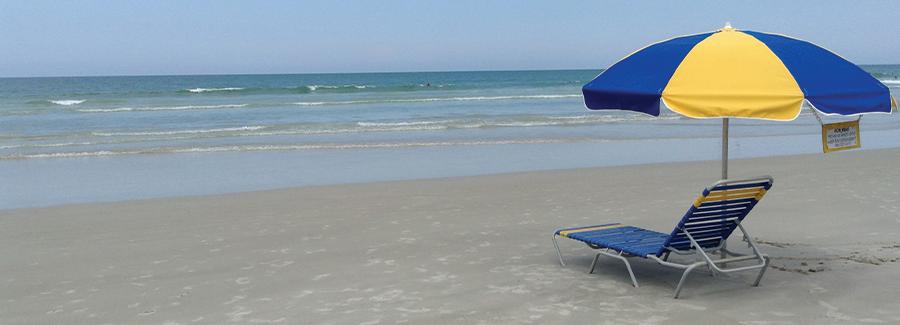 Rent an umbrella chair for a day and relax on Daytona Beach