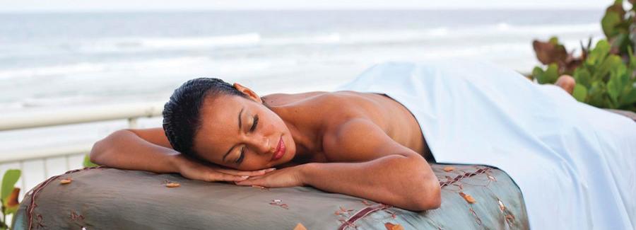 A visitor enjoys relaxing on the oceanfront after a spa treatment