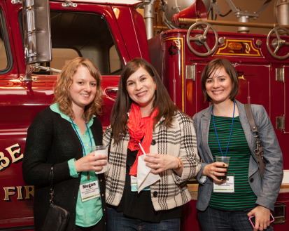 women in front of a fire truck