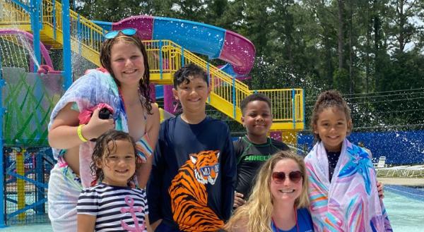 Image of children and a woman in sunglasses at a Cumberland County splash pad
