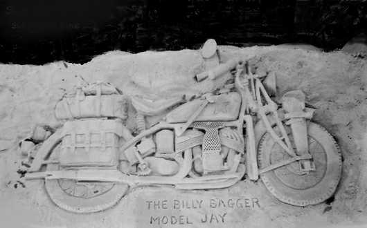 A motorcycle is carved into sand