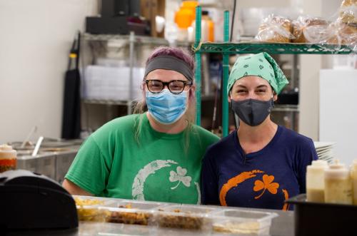 o	Two women wearing facemasks at Orange Clover Kitchen in Southern Indiana