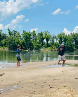 kids playing on river's edge with water guns