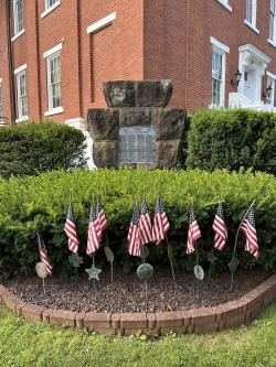Picture of the Union County Courthouse Keystone monument with may American flags Infront of it.