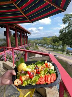 Food held infront of pretty view off patio at Skeeter's BBQ
