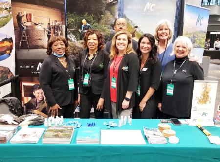 Ashby Brame, Johston County VB public relations manager, promoting Johnston County, NC at a trade show.