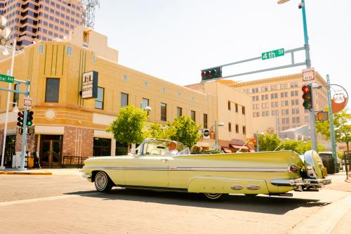 A lowrider cruises through the intersection of Central Ave. and 4th Street in Downtown Albuquerque.