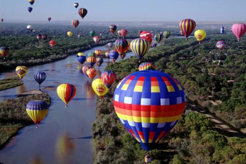 Hot air balloons float over the Rio Grande