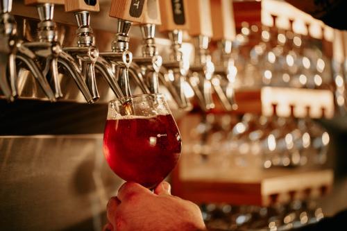 An amber beer being poured from a tap.