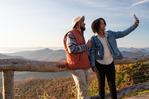 Two visitors take a selfie on the Blue Ridge Parkway near Asheville, NC