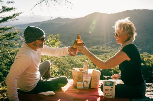 Two people having a picnic during sunset at Lunch Rocks Trail