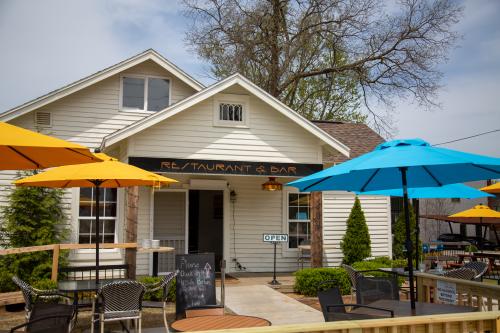 White building with an outdoor patio with colorful umbrellas