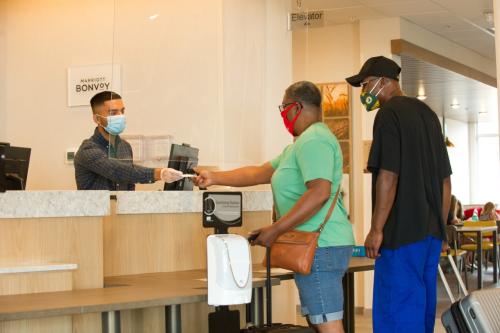 People in masks checking in at Fairfield in Southern Indiana