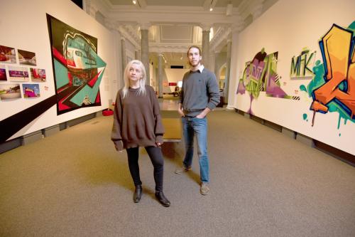 Couple Standing in Carnegie Center for Art & History graffiti exhibit.