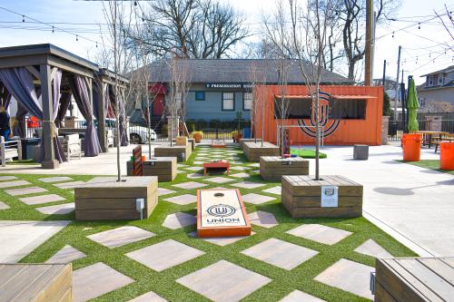 Outdoor space with tables and games at the Union GameYard in Jeffersonville, IN