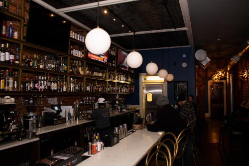 People sitting at the bar at The Earl in New Albany, IN