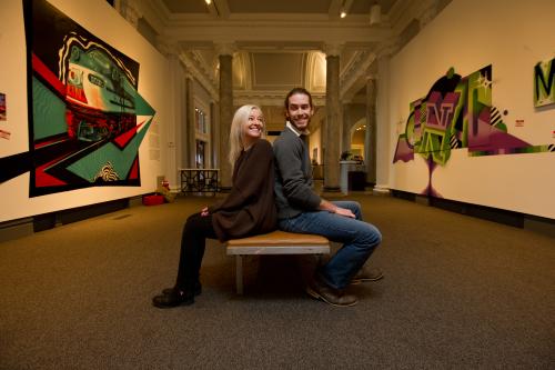 Couple sitting back-to-back at the Carnegie Center Graffiti