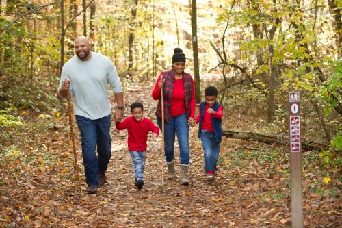 Family hiking Deam Lake Knobstone Trail in the fall