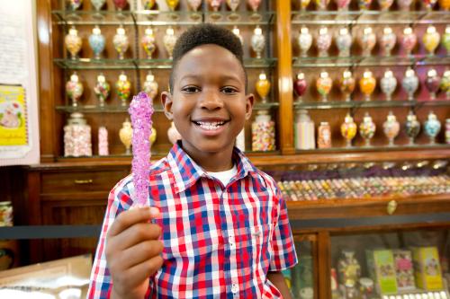 Boy holding candy at Schimpff's Confectionery