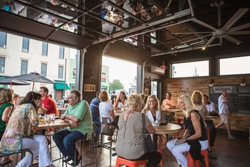 Patrons sitting at tables at The Exchange Patio in New Albany, IN