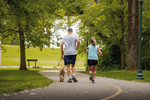 Couple running with their dog on the Ohio River Greenway