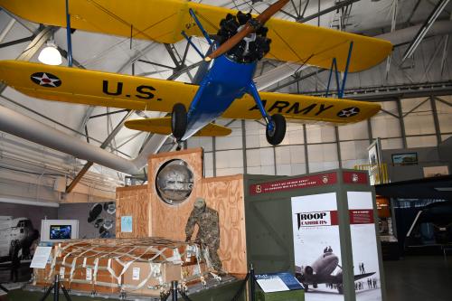 Props, including a model airplane and army gear, positioned at the Air Mobility Command Museum.