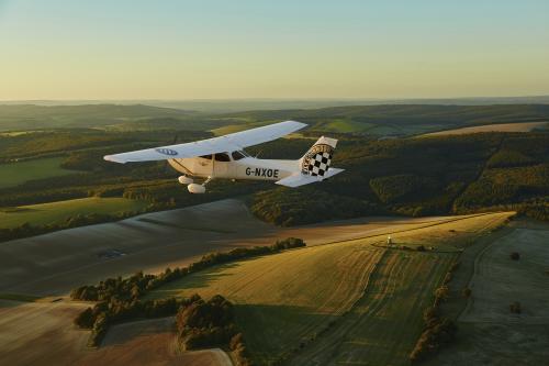 A plane flying over Sussex countryside