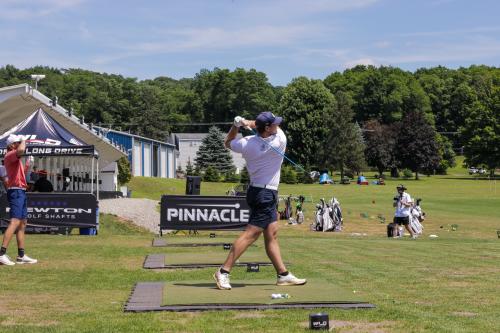 Golfer in shorts mid-swing at the World Long Drive Championship