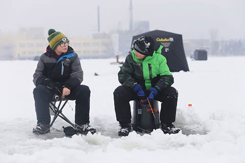 Two kids ice fishing