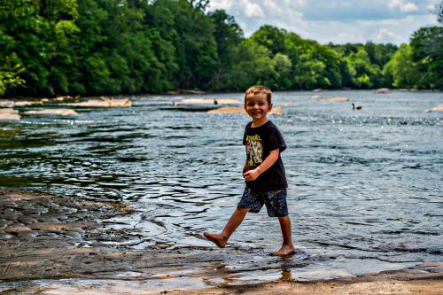 Boy walking near the bank in Chattahoochee River