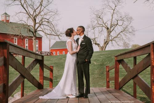 Married Couple Kissing on Avon Wedding Barn Bridge