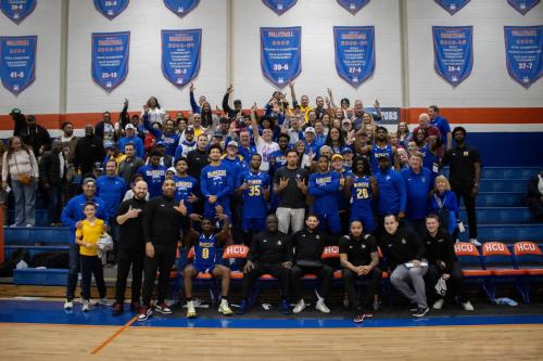 mcneese men's basketball team poses with fans after a game