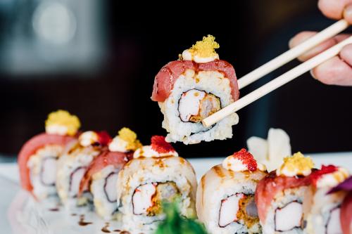 A patron enjoys a fresh sushi roll at eeZ Fusion in Huntersville, NC.