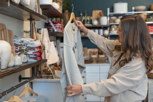 woman holding sweatshirt at graced