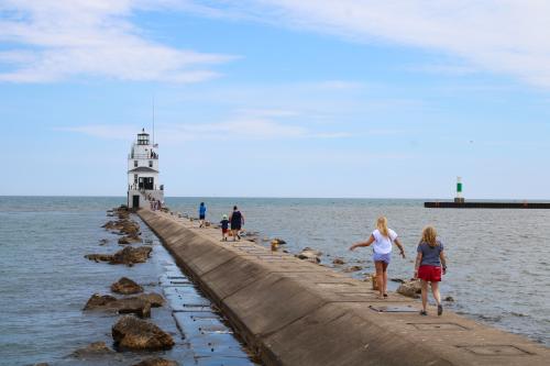 People walking to Manitowoc Breakwater Lighthouse