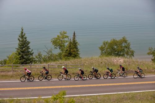 Cyclists riding on the road along the lakeshore