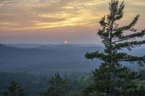 View of a warm summer sunset from Sugarloaf Mountain in Marquette, MI